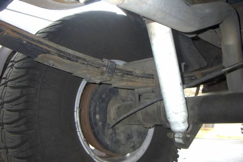 1994 Ford Bronco - Close-up view of the rear suspension and axle components of a vehicle.