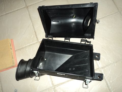 2004 Mercury Grand Marquis - Air cleaner housing and filter shown on a tiled floor.