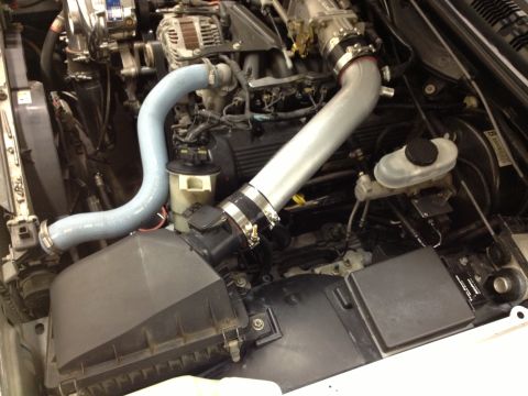 1998 Ford Crown Victoria - Custom intake pipes installed in an engine bay, focusing on the air intake system.