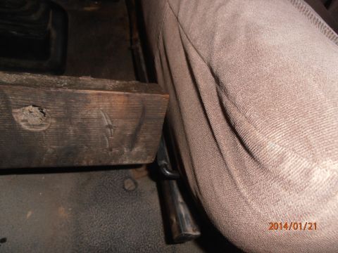 1996 Ford Bronco - Close-up interior shot of a vehicle, focusing on a wooden block and seat upholstery.