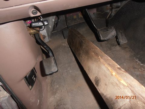 1996 Ford Bronco - Interior view of vehicle pedals with a piece of wood on the floor.