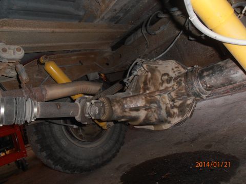 1996 Ford Bronco - Close-up of the rear axle assembly and suspension components of a vehicle.