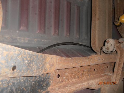 1996 Ford Bronco - Close-up view of the undercarriage and bed of a vehicle, showing significant rust.