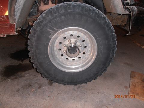 1996 Ford Bronco - Close-up of a vehicle's wheel and tire, showing off-road tread pattern.