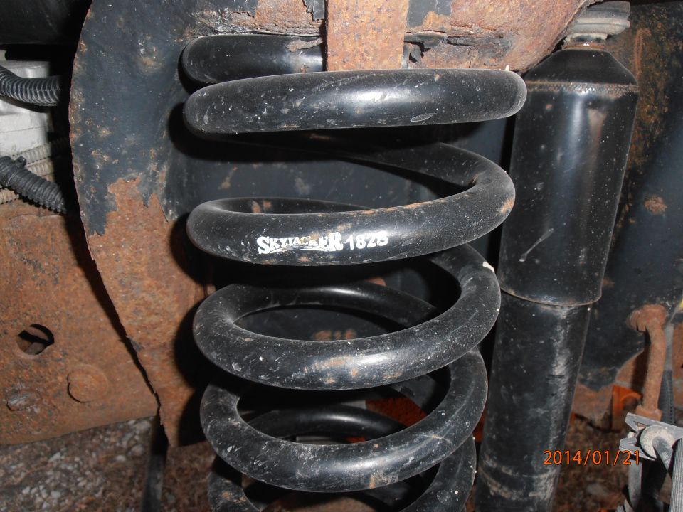 Suspension coil spring with "SKYJACKER 1825" text