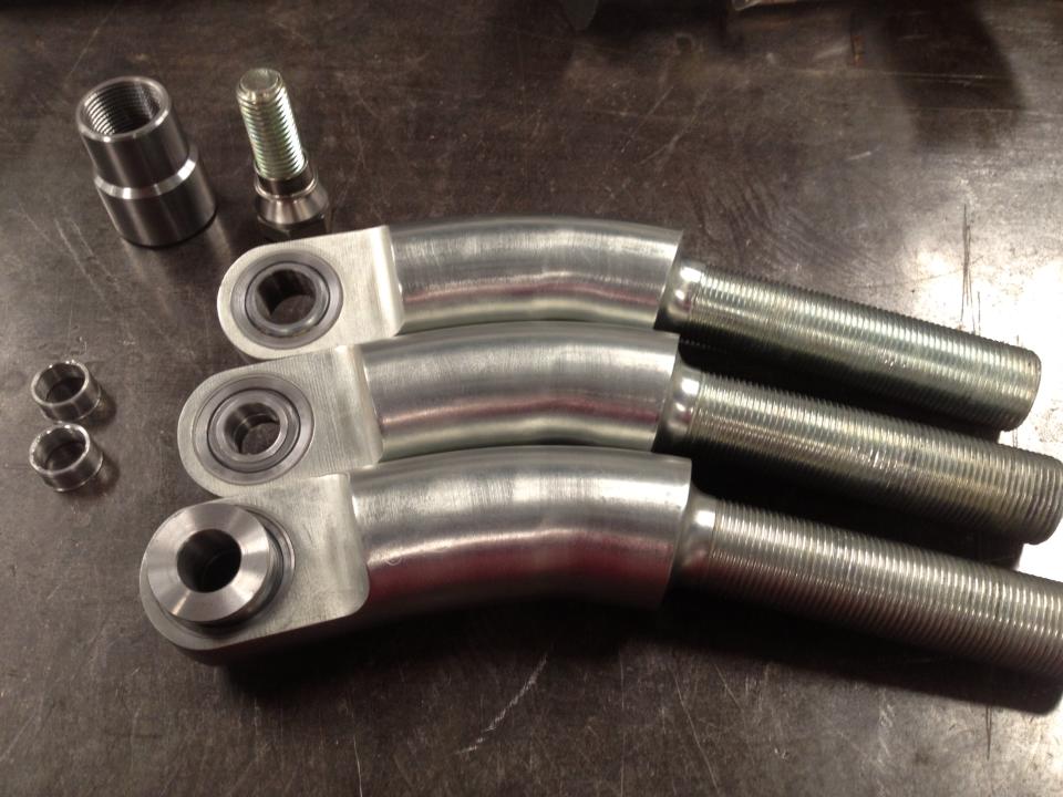 three metal suspension arms with threaded ends and bearings, plus a bolt and threaded sleeve
