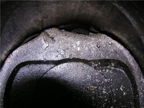1993 Ford Bronco - Close-up view of a damaged piston and cylinder wall, indicating severe engine wear or failure.