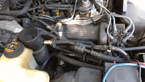 1996 Lincoln Town Car - Close-up view of a car's engine bay, showing various components and wiring.