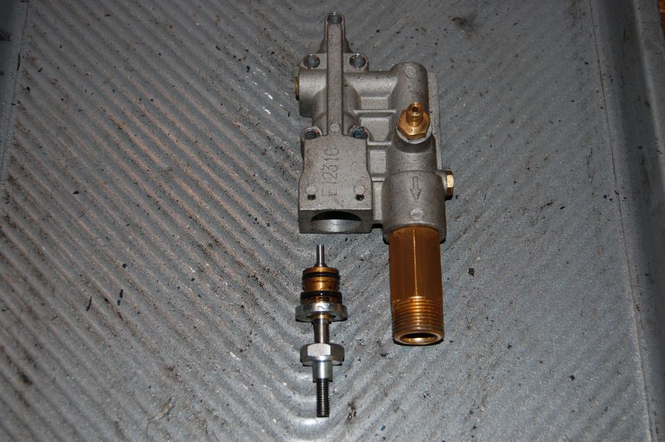Pressure washer unloader valve assembly with internal components removed. Part number F1231C visible