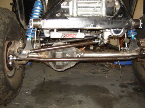 1985 Jeep CJ7 - Custom suspension and steering components are visible on this off-road vehicle's front axle.