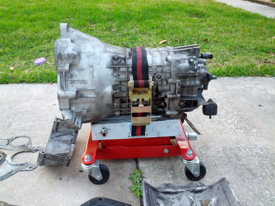 Getrag transmission on a red stand, with straps holding it