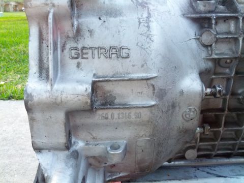 1989 BMW 3 Series - A close-up view of a GETRAG 260 transmission part, showing stamped numbers and the BMW logo.
