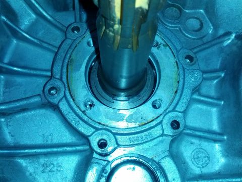 1989 BMW 3 Series - A close-up view of a metal transmission housing with a shaft and visible part numbers.