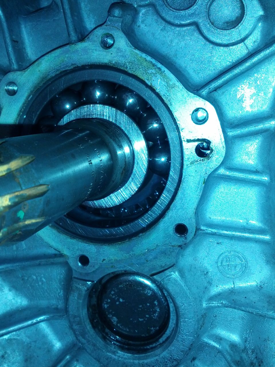 Close-up of a transmission bearing with visible ball bearings and a metal shaft