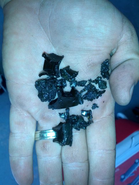 1989 BMW 3 Series - Fragments of black plastic are held in a hand, likely debris from a GETRAG 260 transmission.
