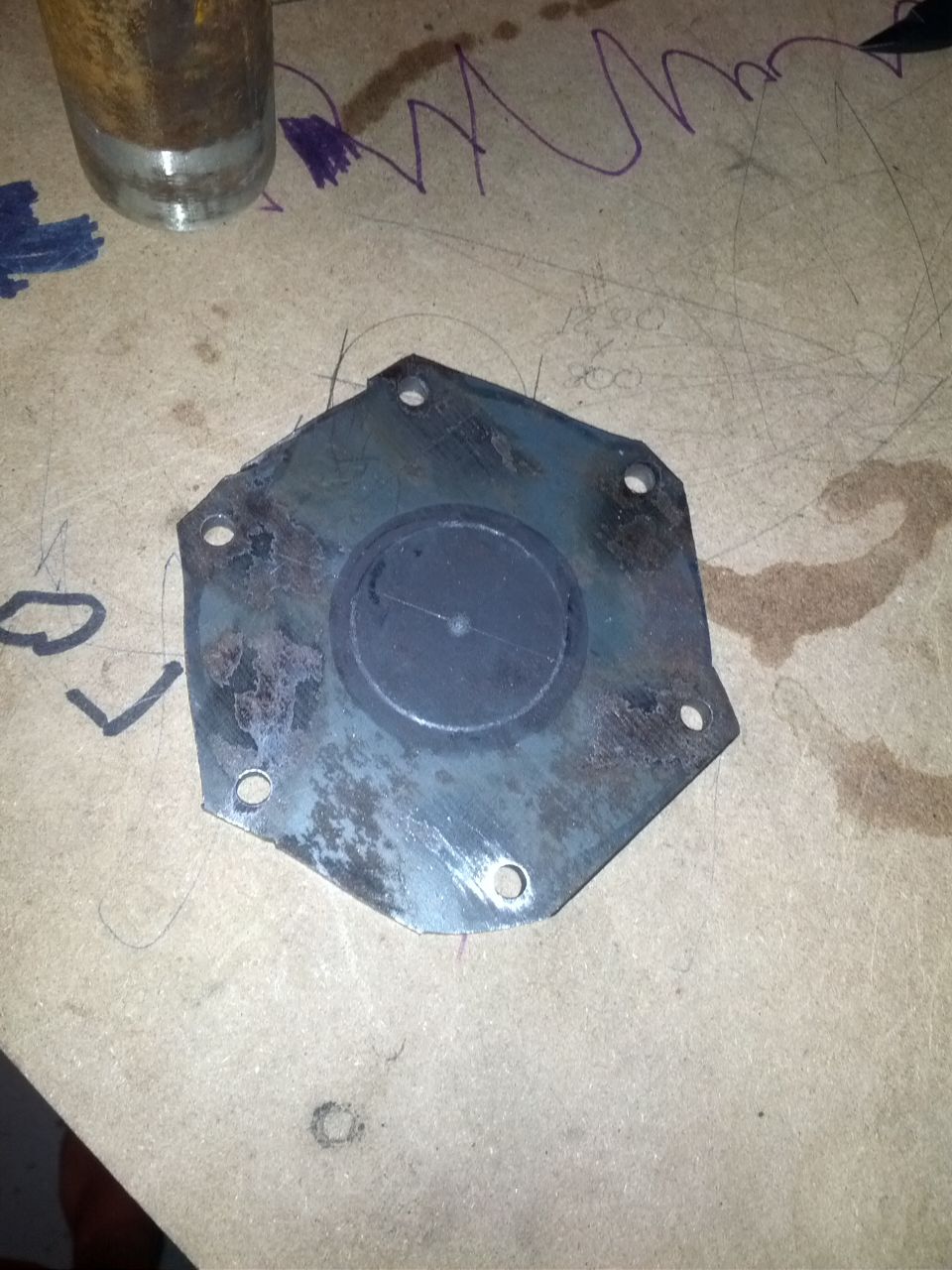 metal plate with a rubber seal on a workbench