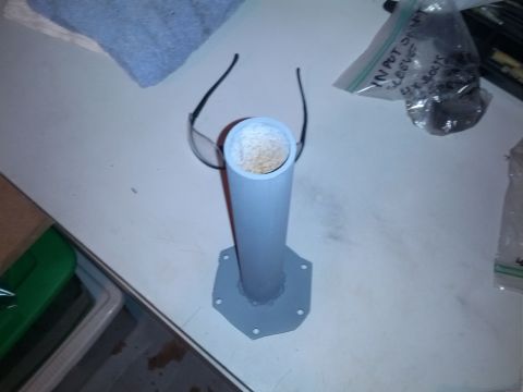 1989 BMW 3 Series - A pipe assembly with glasses on top sits on a workbench next to a bag of bolts.