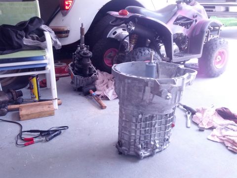 1989 BMW 3 Series - Transmission components are laid out on the floor next to an ATV.