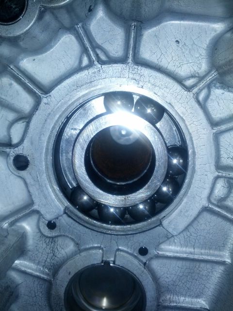 1989 BMW 3 Series - Close-up of a ball bearing assembly within a metal casing, showing wear and cracking.