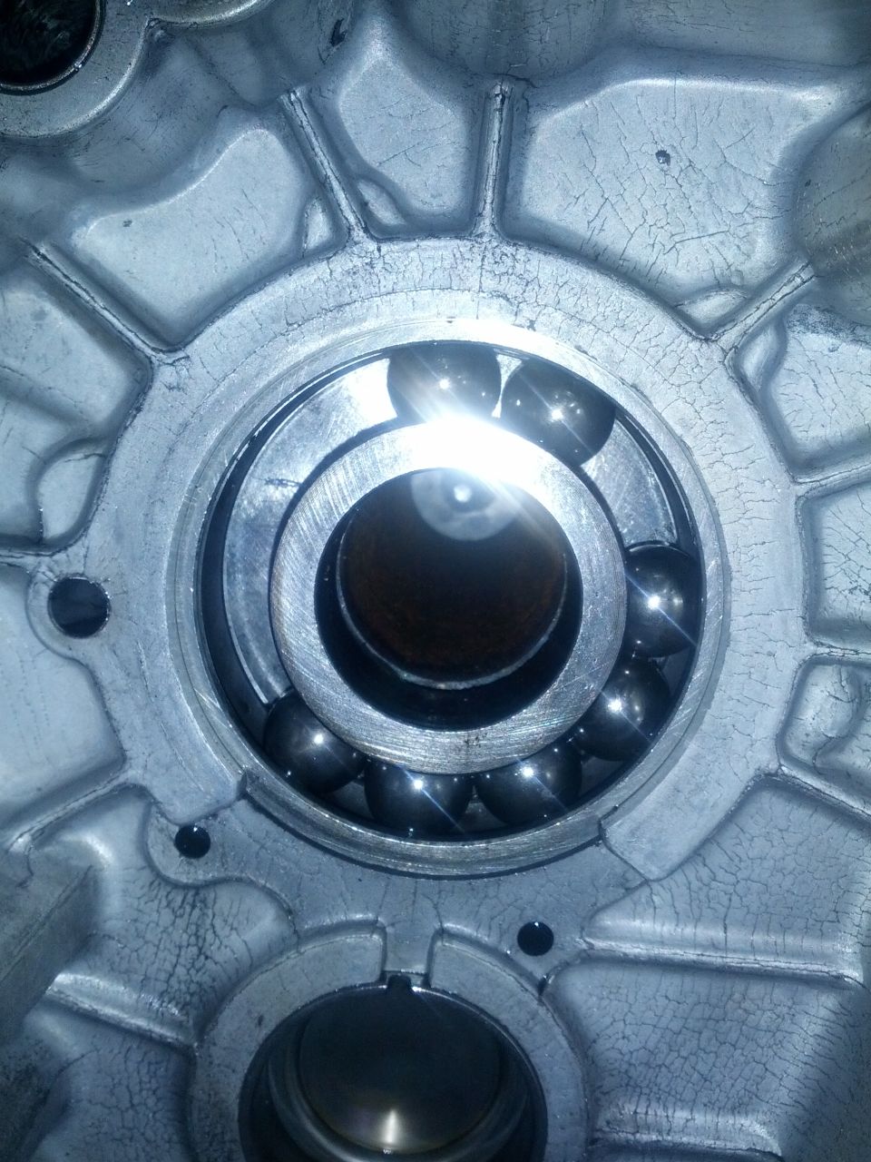 Ball bearing with multiple steel balls inside a cracked aluminum housing