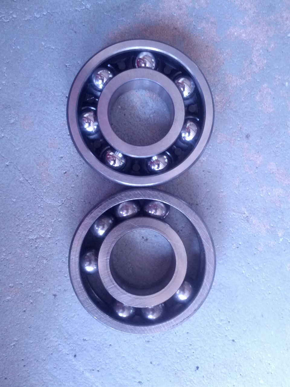 Two ball bearings on a textured surface