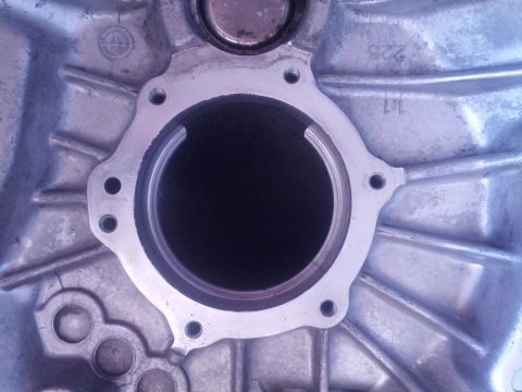 1989 BMW 3 Series - Close-up view of a metal transmission housing part, showing casting marks and a central opening.