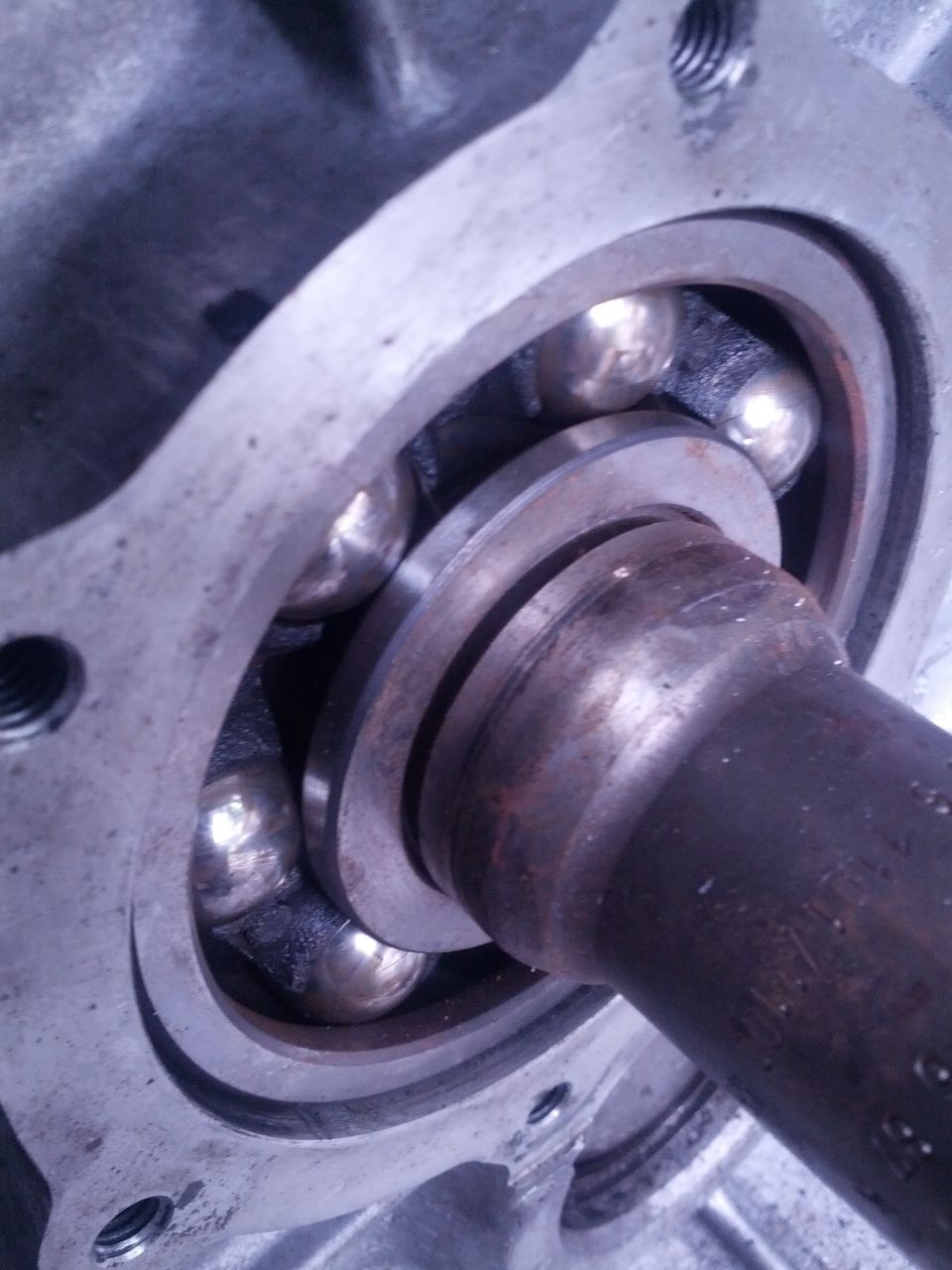 Close-up of a ball bearing assembly with a metal shaft