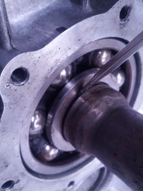 1989 BMW 3 Series - A screwdriver is used to pry a bearing within a transmission housing.