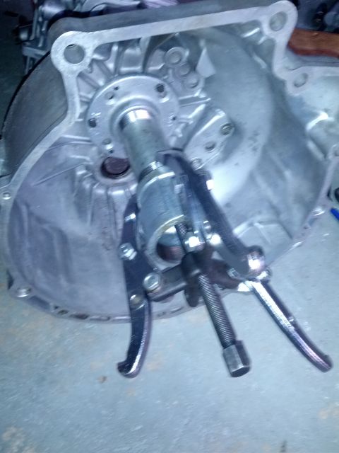 1989 BMW 3 Series - A puller tool is attached to a shaft within a transmission housing.