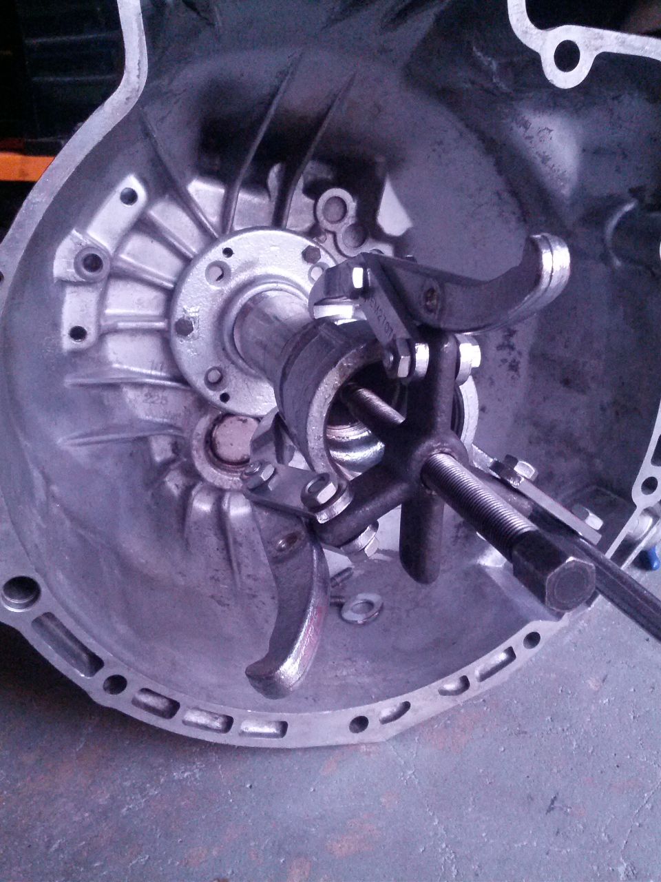 Transmission bell housing with clutch release mechanism tool