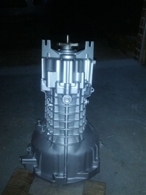 1989 BMW 3 Series - Transmission housing, likely for a manual gearbox, painted silver and photographed indoors.