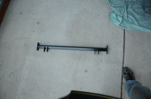 1979 Ford Bronco - A black metal bar with four prongs is visible on a concrete surface.
