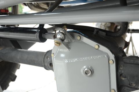 1979 Ford Bronco - Aftermarket steering stabilizer and differential cover installed on a vehicle's axle. Supermotors.net logo is visible.