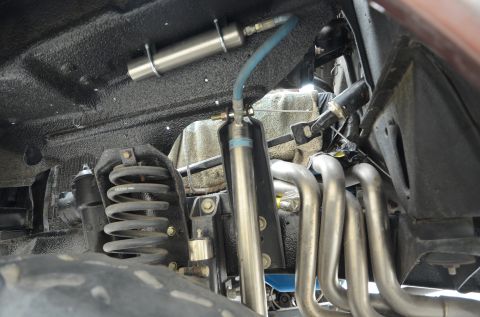 1979 Ford Bronco - Close-up view of the undercarriage components, including shocks and exhaust system.