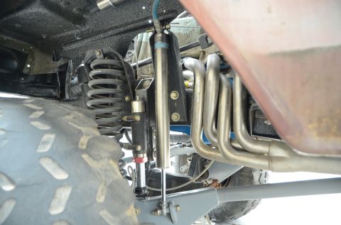 1979 Ford Bronco - Detail view of the suspension components and exhaust headers, showing the complexity of the vehicle's undercarriage.