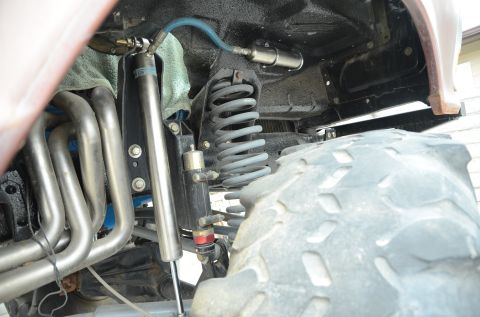 1979 Ford Bronco - Off-road vehicle suspension components including shock absorber, coil spring, and exhaust headers are visible.