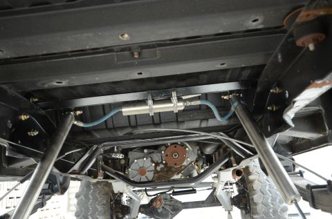 1979 Ford Bronco - Undercarriage view reveals the drivetrain and suspension of a modified vehicle.