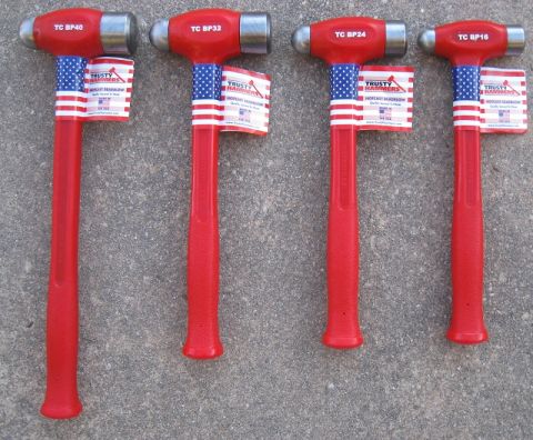 2000 Ford Crown Victoria - Four Trusty Hammers dead blow hammers are displayed on a concrete surface.