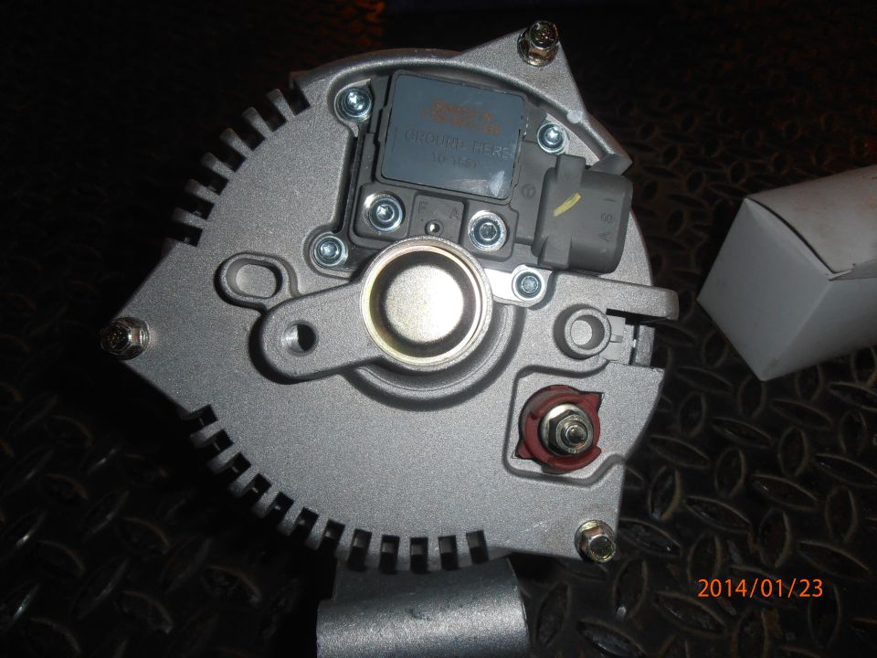 Close-up of an alternator with visible text on a blue label