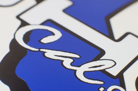 1993 Ford Taurus - Detail of a blue and white decal with script lettering, likely a sticker or emblem.