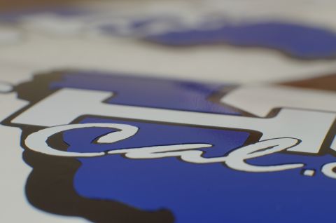 1993 Ford Taurus - A close-up shot focuses on a decal with blue and white lettering, showing part of the word "Cal."
