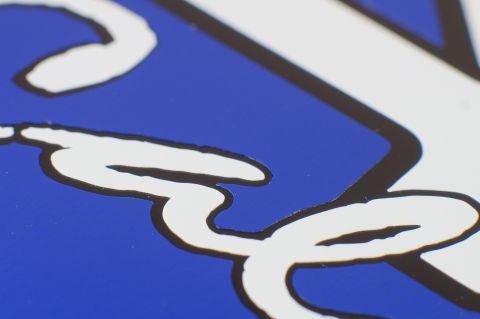 1993 Ford Taurus - Close-up of a blue decal with white cursive lettering and a black outline.