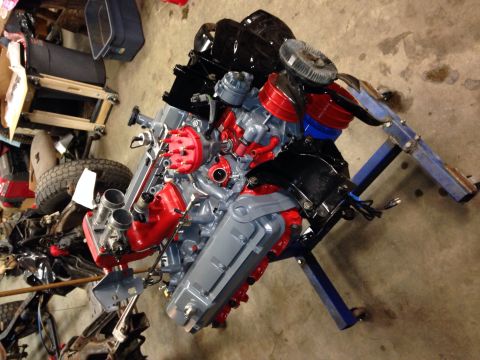 1993 Ford Bronco - Engine assembly on a blue engine stand in a garage setting.