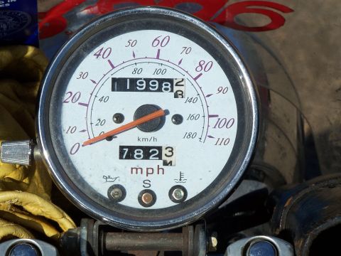 1998 Honda Shadow VT750C - Close-up of a motorcycle's speedometer displaying the year 1998 and 7823 miles.
