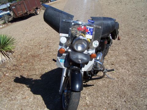 1998 Honda Shadow VT750C - Front view of a 1998 Honda Shadow VT750C motorcycle with a large black fairing and windshield.