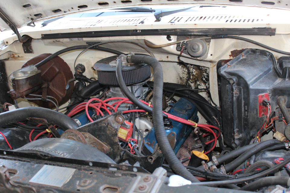 1982 Ford Bronco engine bay with blue valve covers and aftermarket air cleaner
