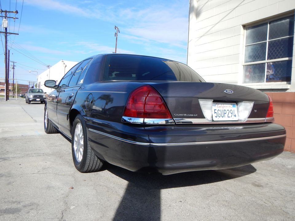 Rear of a dark Ford Crown Victoria LX with plate 5GUP294