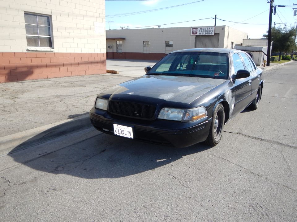 Black Ford Crown Victoria front three-quarter view with California plate