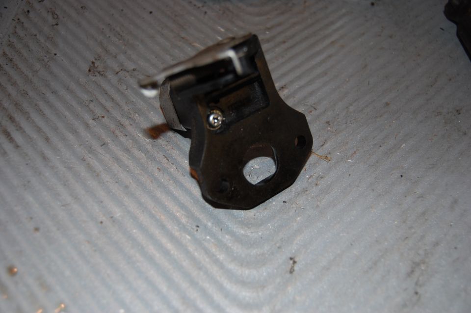 Black metal part with screw and cutout