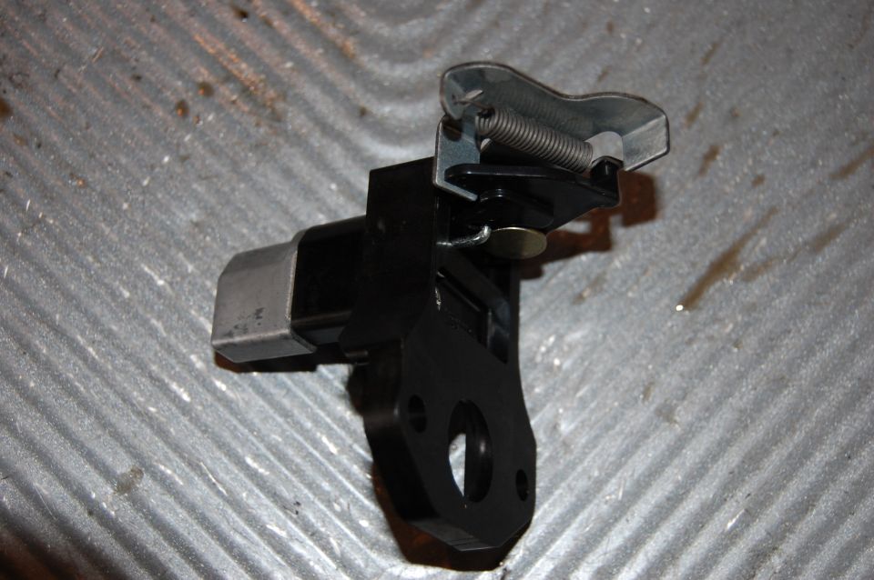 Carburetor linkage mechanism with spring and mounting bracket